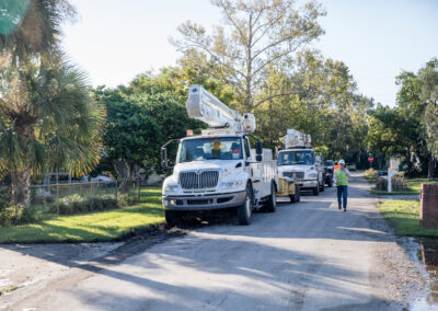 White bucket truck parked in a neighborhood.